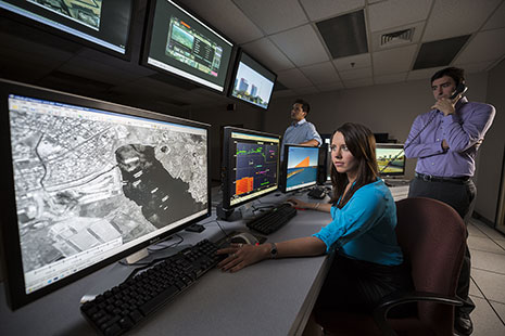 Engineers monitoring computer displays